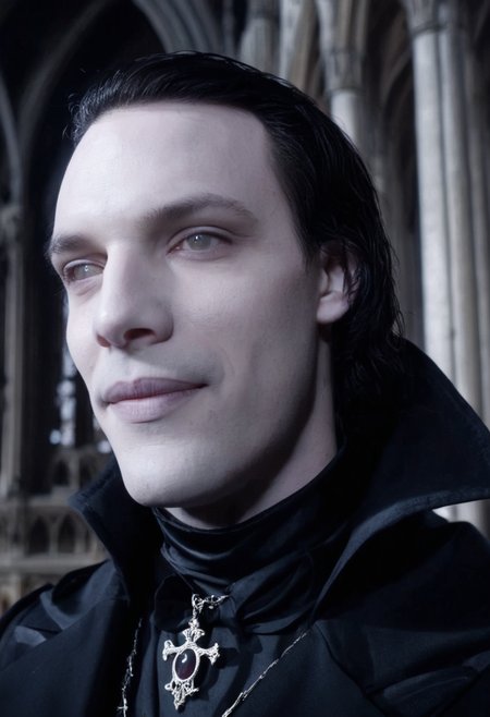 cinematic film still close-up of a deathly pale vampire man smiling, dark hair, wearing black victorian suit and cape, standing in a gothic cathedral <lora:corpse:1>