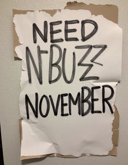 decayart, sign written "Need N-BUZZ NOVEMBER"