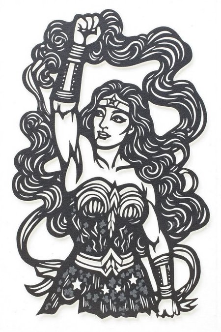 papercut art of 
Wonder Woman looking up with fist raised, carvevd with mottled dark grey stone 
 <lora:papercut1_cap_d6a3e12:1.0><lora:823261195596356414:0>