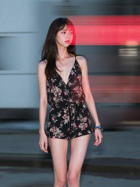 There are wonderful studio lights and various reflections,
18yo beautiful cute girl with blushing and female orgasm.skin naturally showing the texture of blood vessels and detailed pale skin,
--,
<lora:Nakajo_Ayami_f1:1>,she is Nakajo Ayami,
(Floral_printed_romper:1.5),(Wedge_sandals:1.4),(Stacked_bangles:1.3), Lines of Movement, HAS12345.3FR, A young woman dominates the frame, partially obscured by streaks of fast-moving digital text in red and black. Her expression is calm and composed, her dark eyes focused ahead with a quiet intensity. The lighting is soft and cool, highlighting the smooth texture of her skin and her hair, which blends with the shadows of her. The woman stands in an urban setting, but the background is blurred with motion, fading into soft grays and blues, indicating the city but leaving it abstract.The red streaks of digital text, sharp and bright, cut across the scene horizontally, giving the image a futuristic, cyberpunk feel. The contrast between the womanâs soft, natural features and the harsh, glowing text creates tension, as though she exists between two worldsâone of calmness and one of fast-paced digital information. The composition draws the viewerâs eye to the womanâs face while also directing attention to the moving text that surrounds her. The interplay of light and shadow is subtle, allowing the glowing text and the woman's focused gaze to take precedence.The overall atmosphere is mysterious and slightly futuristic, evoking themes of technology, modern life, and isolation in a digital world. The image suggests a person in tune with both the physical and digital environments, navigating between them with ease.,#æ°å­åçº¿èå