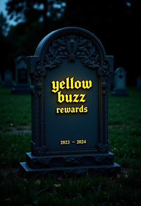 This is a photograph taken at night of a gravestone dedicated to "Yellow Buzz Rewards" in a cemetery setting, taken in a grassy environment. The gravestone is intricately carved in the appearance and features a modern design. The name "Yellow Buzz" is engraved in a bold, yellow color, Gothic-style font on the front of the stone, the word "Buzz" emits a subtle glow, and the text "2023 - 2024" is inscribed beneath it.