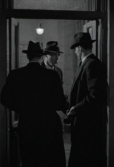 In 1950s Chicago, hotel exterior at night, several gangsters enter the front door. Captured with a 35 mm camera, black and white, classic film noir film.