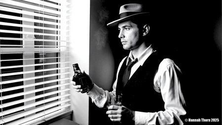A solitary, brooding man in his mid-30s, dressed in a classic fedora, crisp shirt, and tailored vest, holds a whiskey glass and bottle, his hardened gaze fixed contemplatively through stark Venetian blinds. The scene is imbued with the dramatic chiaroscuro of Caravaggio and the gritty realism of John Alton's film noir cinematography. Captured with a vintage medium format camera, 80mm f/2.8 lens, low-angle perspective. Intense, directional key light slices through the blinds, casting sharp horizontal shadows across his face and attire, complemented by a soft, hazy rim light from the upper right, revealing subtle atmospheric smoke. Composition employs strong diagonal leading lines and off-center subject placement, enhanced by deep black and white conversion, fine film grain, subtle vignetting, and high-contrast post-processing for a timeless, realistic noir aesthetic.<lora:_Flux\_Film-Retro\Film_Noir.safetensors:0.8000000000000002:0.8000000000000002>