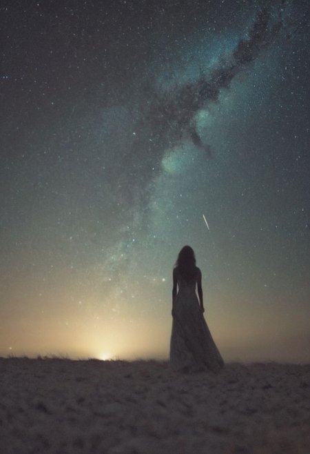 In the embrace of the night's vast expanse, a solitary figure emerges, her silhouette a graceful dance against the deep indigo sky. As the Milky Way casts its gentle glow, she stands, a beacon of strength and resilience amidst the quiet expanse.
With the soft rustle of feathers and hair, she embodies the spirit of her ancestors, a warrior in her own right. In her hand, she holds not just a spear, but a symbol of defiance against the encroaching darkness, a testament to her unwavering spirit.
The low-toned hues of the Milky Way paint a tapestry of dreams and possibilities behind her, a cosmic backdrop to her earthly journey. In this nocturnal tableau, tradition and innovation converge, blending seamlessly into the fabric of her existence.
In her busty silhouette lies the promise of untold tales, where the spirit of the Indianer woman intertwines with the pulse of a world in constant motion. Against the backdrop of the night, she stands, a vision of beauty and strength, ready to carve her own path through the ever-shifting sands of time.