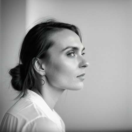 kiev80 A breathtaking, high-end black-and-white portrait of a 25-year-old woman, a vision of natural beauty and effortless elegance. Her face is the absolute focal point—her deep, expressive eyes radiate warmth and mystery, while her delicate features and flawless skin are illuminated by masterful chiaroscuro lighting. Every detail is captured with precision: the gentle curve of her lips, the soft glow on her cheekbones, and the way the light and shadow sculpt her face, creating a timeless, almost cinematic allure. Her expression is both captivating and inviting, evoking a sense of intimacy and admiration. The background is minimalist and softly blurred, ensuring undivided attention on her radiant presence. Inspired by the iconic works of Peter Lindbergh, Richard Avedon, and Helmut Newton, this portrait exudes sophistication, depth, and an irresistible charm that makes her unforgettable.