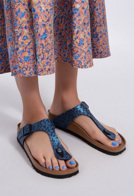 1girl, solo, simple_background, white_background, gizehonfeet, blue_toenail_polish, close-up, lower_body, footwear_focus, patterned, long_skirt
