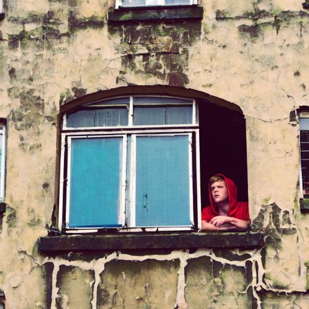 1boy, metal, hood, upturned, window, wheels, urban, sky, metal grid, wall corner