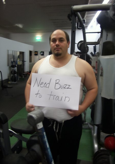 Chubby plump fat (unhealthy:1.3) gamer incel man in a gym wearing white tanktop holding a sign saying in a big font "Need Buzz to train", gym equipment in foreground, weights on ground
 <lora:Ugly:1>
 <lora:Amateur_Photo2:1> 2007