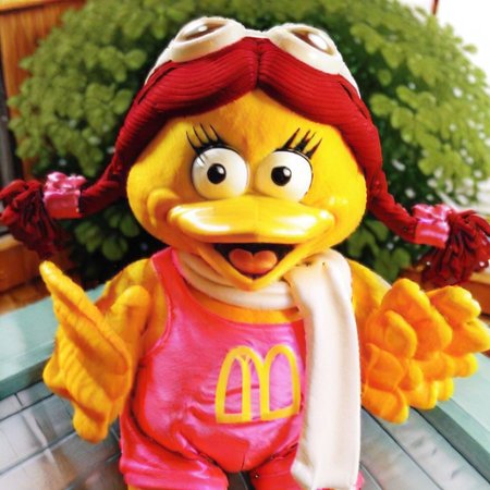 m symbol  on  chest, black  eyes, talen feet, 3D, red pigtails hair, yellow  bird, white scarf, goggles on top of  head, yellow beak, pink romper, feather hands, Birdy, female anthro