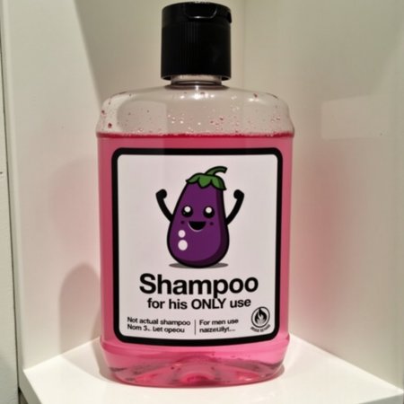 This is a picture of a shampoo bottle. It is a clear plastic bottle with a rectangular shape and a white label with black border. The label depicts a cartoon eggplant with strong hands and a smiley face. The front of the label features prominent black bold text "Shampoo".  Below this, in smaller text, it reads "for his ONLY use" in black. The features are specified as "Not actual shampoo" and the text "For men use only" is printed at the bottom right corner. The bottle contains a translucent pink liquid. The bottle is sitting on bathroom shelf.