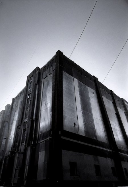 detailxl, 80sc1nemat1c5tyle, creamy bokeh, monochrome, BREAK, never ending line of buildings far away to the horizon, oppression