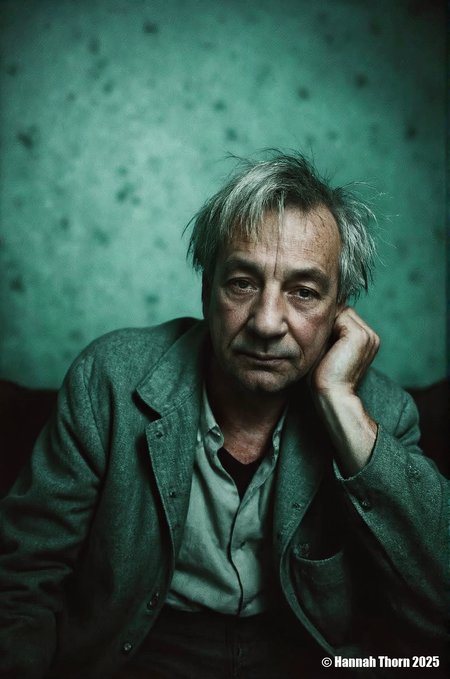 The image presents a haunting scene of an elderly man in a state of distress, reminiscent of Vincent van Gogh's portraits. His face bears the marks of time and hardships on his skin, with noticeable age spots and wrinkles etched into it. The bluish-green tone adds to the overall sense of melancholy and loneliness that seems to emanate from this man.  The composition is masterful, using depth of field techniques to isolate him in a space bathed in muted green and blue hues. His position in the foreground draws immediate attention while subtly blurring the background, creating an intimate feel between the viewer and the subject. The camera's perspective is from slightly below his eye level, enhancing this connection through the lens.  The lighting setup is dramatic, with a soft yet intense saturation that casts a gentle glow on his features, highlighting his worn-out clothes. The choice of using warm and cool tones intermingles subtly, adding an element of nostalgia to the overall color palette.  The image is rich in detail, inviting the viewer to dive deeper into the subject's world. It's a cinematic piece that captures not just his physical appearance, but also his emotional state - a blend of fragility and resilience.<lora:_Flux\_Photographer\Anders_Petersen.safetensors:1.0000000000000002:1.0000000000000002>