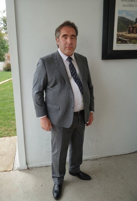 masterpiece, best quality, newest, absurdres, highres, photo, realistic style, full body picture, outside, 1boy, Tubby, fat man hairy man, brunette, green eyes, wearing a suit