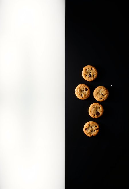 two sides of a table, the left side represents light and is white and empty, the right side is dark and has cookies on a black background <lora:Dever_Flux_Enhancer:0.5>
