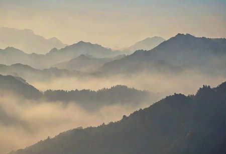 Silhouetted Misty mountains with a soft hazy sky