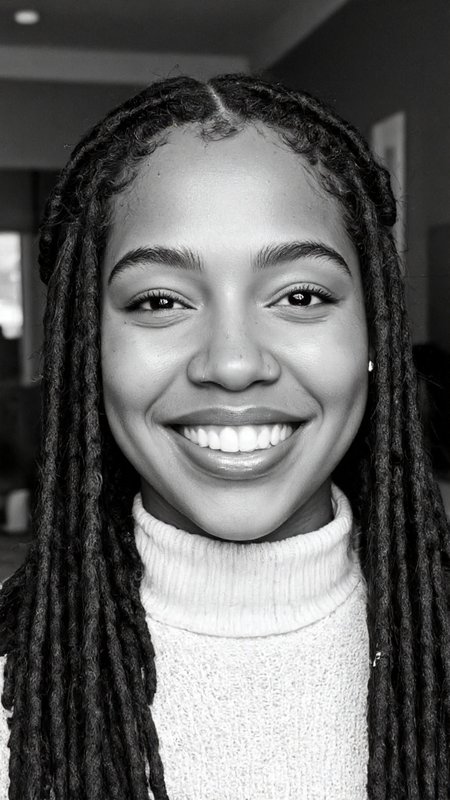 black-and-white photograph of a young woman with a radiant smile, showcasing her beautiful dark skin and natural beauty. She has a confident and warm expression, with her eyes glistening and her teeth gleaming. Her hair is styled in long, thick dreadlocks, which cascade down her shoulders and frame her face, adding texture and depth to the image. She is wearing a high-necked garment, likely a sweater, which contrasts subtly with her skin tone. A small nose ring adorns her left nostril, adding a touch of personal style. The background is out of focus, ensuring that all attention is directed towards her face, which is the focal point of the photograph. The lighting is soft and even, highlighting her features without harsh shadows. The monochromatic nature of the photograph emphasizes the textures and contrasts within her skin, hair, and clothing, creating a striking visual effect that is both timeless and modern. The overall mood of the image is one of warmth, confidence, and natural beauty, captured in a classic black-and-white style that enhances the emotional impact.,aidmaimageupgrader, aidmaMJ6.1 <lora:aidmaMJ6.1-FLUX-v0.5:0.7> <lora:aidmaImageUprader-FLUX-v0.3:0.4>