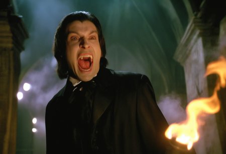 cinematic ultra close-up of a vampire man with pale skin screaming showing (fangs:1.2) lunging at the viewer ,gothic crypt torches, fog, cobwebs, dramatic chiaroscuro, low angle, creepy atmosphere <lora:h4mm3r:0.8>
