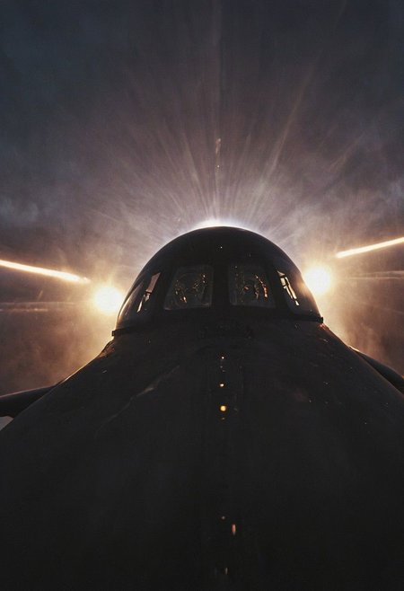 Create a vivid description capturing the essence of a close-up photograph inside the cockpit of a sleek, matte-black futuristic jet in flight. Highlight the discernible details: the pilot, confidently and mischievously smiling, with focused eyes locked onto the target. Convey a sense of high-speed motion, surrounded by billowing neon-pastel clouds, encapsulating the exhilarating and dynamic atmosphere within the cutting-edge aircraft.
 very detailed, atmospheric haze, Film grain, cinematic film still, shallow depth of field, highly detailed, high budget, cinemascope, moody, epic, OverallDetail, gorgeous, 2000s vintage RAW photo, photorealistic, candid camera, color graded cinematic, eye catchlights, atmospheric lighting, skin pores, imperfections, natural, shallow dof,iran