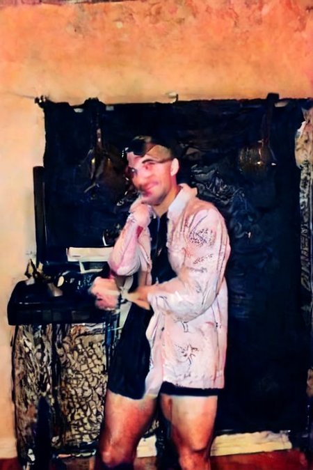 ((SFW)),  wearing a trench coat, leather gloves, and aviator goggles, light smile, mind-expanding,  sitting in office masturbating while on the phone with someone, gay porn on the computer, man surprised
