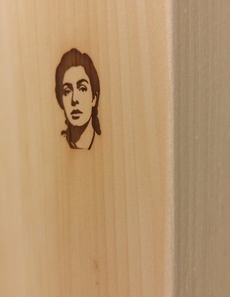 Close-up shot of a standard 2x4 wooden stud, with a few faint scratches etched into its surface. The wood grain is visible through the paint, giving it a slightly textured appearance. A face of a woman is engraved into the side of the 2x4., <lora:amateurphoto-v5-14-15-1-1:0.4> <lora:Another_Amateur_Lora:0.4> <lora:Phlux:0.4> <lora:UltraRealistic_Lora_Project:0.4>