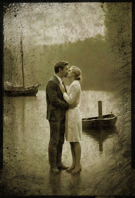 klskx , AgedSepiaCE, masterpiece, best quality, amazing quality, 1900s dock at sunset, raining, sailing schooner in background, two lovers dressed in 1920's attire, kissing in the middle of the scene, perfect composition, highly detailed background, 1man, 1woman, standing on dock, passionate romantic kiss, depth of field, ((((kissing)))), passion, love , masterpiece, best quality