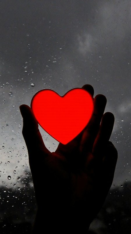 photograph featuring a close-up of a hand holding a red heart-shaped object against a monochromatic backdrop. The heart is illuminated from within, creating a vivid contrast against the surrounding darkness. The hand, silhouetted against the background, is positioned at the bottom right corner of the image. The background consists of a gray sky with raindrops, which are captured on the glass surface, adding a textured, almost abstract quality to the scene. The raindrops vary in size and are spread across the entire image, creating a sense of wetness and a reflective surface. The heart, though not fully visible, appears to be made of a smooth, glossy material, possibly glass or plastic, with a reflective surface that captures light and distorts the surrounding raindrops. The overall mood of the photograph is somber and melancholic, enhanced by the monochrome background and the stark contrast between the red heart and the surrounding darkness. The image evokes a sense of solitude and introspection, with the heart symbolizing love and the raindrops symbolizing emotion or tears.,aidmaimageupgrader, aidmaMJ6.1 <lora:aidmaMJ6.1-FLUX-v0.5:0.7> <lora:aidmaImageUprader-FLUX-v0.3:0.4>