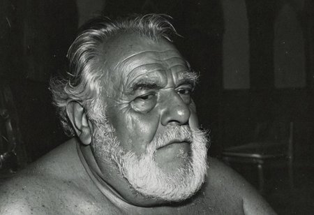 grainy nighttime lowlight photograph, dark room,
masterpiece, 4k, solo, alone, 
tall old hairy tanned grandpa with hairy chest, bullish chubby face with doublechin, face portrait, bushy eyebrows,
father, vater, uncle, onkel, stepdad, stiefvater, grandpa, opa,
gentle charming expression, romantic, intimate, 
sitting in a chair in a dark cloister chapel,