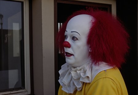 <lora:no-blur:1>,  <lora:Pennywise_91:1>,  <lora:flux_realism_lora:0.5>,  <lora:olympusd450_lora:1.5>,  <lora:perfection style v1:0.5>, Pennywise_91,  olympusd450
Pennywise in High-Resolution Horror Profile
This is a high-resolution photograph capturing Pennywise the Clown in a side profile, emphasizing his eerie and unsettling presence. His pale white complexion starkly contrasts with the deep shadows cast by the dramatic lighting. Pennywiseâs fiery red hair, wild and untamed, flares out messily from the sides of his head, catching the dim light that streams in from the right, illuminating the sinister features of his gaunt face.
His piercing blue eyes are fixated on something in the distance, gleaming with malevolent intent. The heavy black eyeliner and mascara emphasize the unnatural depth of his gaze, while the exaggerated red smile, painted in a twisted, jagged curve, cuts across his face, hinting at the evil lurking beneath his clownish exterior. His expression is calm yet deeply disturbing, with a faint, knowing grin that promises something far more terrifying.
Attire: Pennywise is dressed in his signature oversized yellow clown suit, adorned with large, worn red pompoms down the front. The once vibrant yellow fabric is slightly faded, casting a grim tone on what should be a cheerful outfit. The large, white ruffled collar encircling his neck is tattered and stained, adding to the decayed, unsettling nature of his appearance. His red hair contrasts sharply with the muted tones of his suit, creating a stark, disturbing visual.
Lighting and Shadows: The dramatic sunlight streaming in from the right casts deep shadows across Pennywise's sharp cheekbones and hollow eyes, highlighting the texture of his cracked makeup and giving his features an almost three-dimensional, lifelike quality. The light plays across the ruffled collar and shiny fabric of his suit, making his grotesque smile all the more unnerving.
Background: An abandoned urban setting, with crumbling buildings and twisted, broken carnival structures barely visible through a shattered glass window. The broken glass reflects the light in jagged patterns, adding an element of chaos to the scene. The soft focus on the background contrasts sharply with the intense, focused detail on Pennywiseâs terrifying profile, drawing the viewerâs attention to the horror in his face.
Mood: The overall atmosphere is one of ominous anticipation. Pennywiseâs still, contemplative posture, combined with the play of light and shadow, creates a deeply unsettling and almost hypnotic image. The photograph captures a moment of eerie calm before inevitable terror, with Pennywiseâs malevolent gaze promising horror to come.
