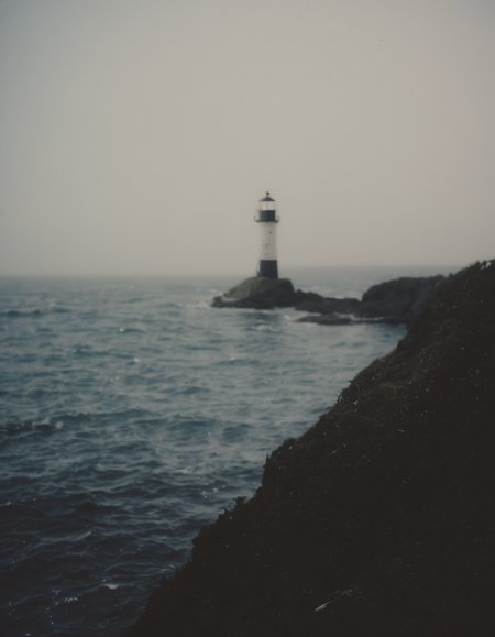 polaroid film photography, faded film, soft focus, film grain, a lighthouse in heavy sea on a shore, 4k, uhd, masterpiece