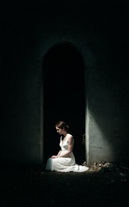 analog film photo A woman sits in the corner of a large dark room,the only light is from the moonbeams coming through a framed window and the only thing illuminated is 50% of the woman and the floor,white dress,lace dress,long dress,tight dress,((closeup)),somber mood,dust particles in the air catch the light,high contrast,long shadows,deep darkness,murky,the room is rundown,room is grungy,graffiti on the walls,vandalized,<lora:add-detail-xl:1>,<lora:- SDXL - vant_blk_contrast_V2.0:1>,approaching perfection,dynamic,highly detailed,smooth,sharp focus,art by Carne Griffiths and Wadim Kashin,trending on artstation,sharp focus,intricate details,highly detailed,by greg rutkowski,mysterious,epic,cinematic, . faded film, desaturated, 35mm photo, grainy, vignette, vintage, Kodachrome, Lomography, stained, highly detailed, found footage