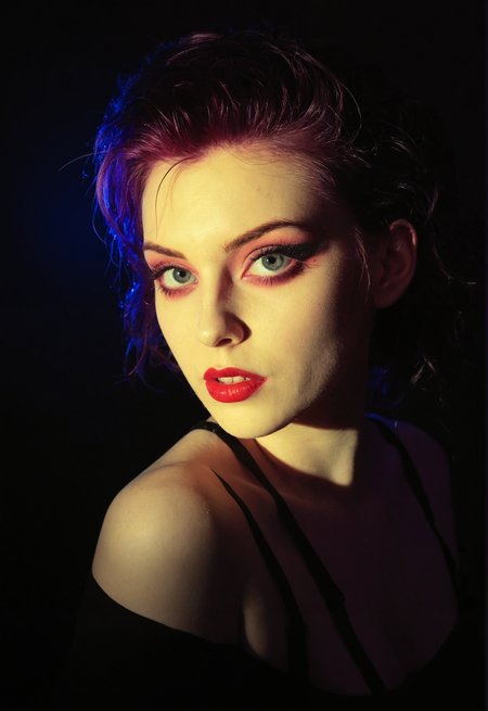 young goth woman, pale skin, 20 years old, (freckles:0.6), (dramatic lighting:0.8), mascara, the cure, 1980s, vintage, neon lighting, rembrandt lighting, noir, pinup, portrait