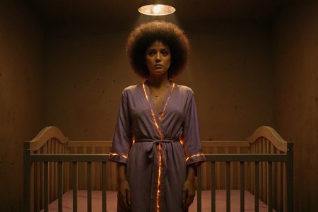 cinematic still, Gina Montana in the Scarface sequel standing barefoot at the center of a crib-shaped altar, brown afro, nursery walls pulsing with invisible heat, lavender robe glowing faintly with ember-thread seams, hair lit like a halo, upper body close-up, symmetrical frontal shot, mood of sacrificial motherhood and theological collapse, spotlight from ceiling fixture overhead, color palette of chalk white, ember rose, and molten pewter, style channeling sacred femininity twisted into quiet despair