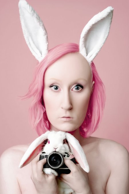 <lora:Photographer Flora Borsi Style:1>Photographer Flora Borsi Style - a woman with pink hair and bunny ears holding a white rabbit in front of her face