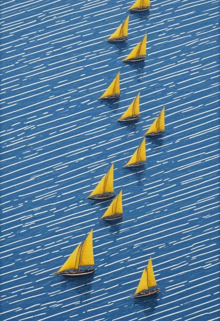 bw-grignani, emphasis lines, horizontal perfect bold lines,  infinite beauty of yellow flying sail ships over serene blue seas, with endless lines guiding the eye.
