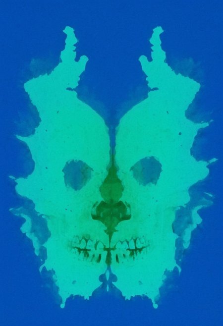A rorschach-test resembling two symmetrical skulls, dark Blue/green translucent ink splashes