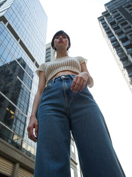 There are wonderful studio lights and various reflections,
18yo beautiful cute girl with blushing and female orgasm.skin naturally showing the texture of blood vessels and detailed pale skin,
--,
<lora:Nakajo_Ayami_f1:1>,she is Nakajo Ayami,
(Knit_cropped_top:1.4),(High-waisted_flared_jeans:1.3),(Platform_sandals:1.2), A bold fashion shot of a model standing tall in front of massive skyscrapers. The low-angle perspective makes her appear powerful and statuesque, her expression strong and determined. The background features towering city buildings with sharp lines contrasting against the bright sky. Street fashion editorial, wide-angle lens, f/2.0, natural light, hd quality,, #æ©å¤©æ¥¼ä½è§åº¦