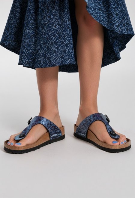 1girl, solo, simple_background, white_background, gizehonfeet, blue_toenail_polish, close-up, lower_body, footwear_focus, patterned, long_skirt