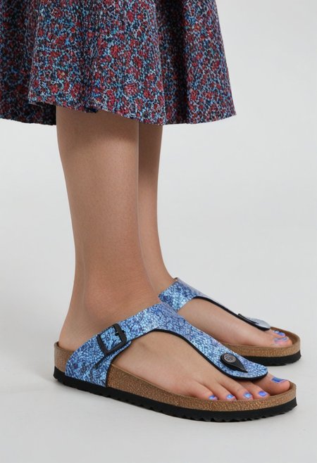 1girl, solo, simple_background, white_background, gizehonfeet, blue_toenail_polish, close-up, lower_body, footwear_focus, patterned, long_skirt