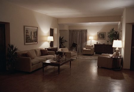 analog film photo Sonny Crockett, Jack Torrance, MiamiVice, CineShining, indoors, Overlook Hotel, room 237, living room . faded film, desaturated, 35mm photo, grainy, vignette, vintage, Kodachrome, Lomography, stained, highly detailed, found footage