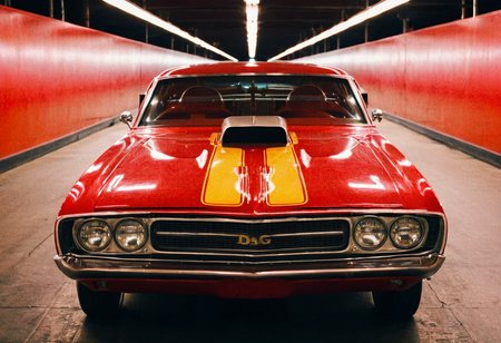 VintageMuscleCar gleaming dragster tunnel, symmetrical front view, bright headlights, neon lights, glass background, light reflections, 4K, highly detailed, closeup (stylish grainy analog film photo 35mm vintage Kodachrome)
