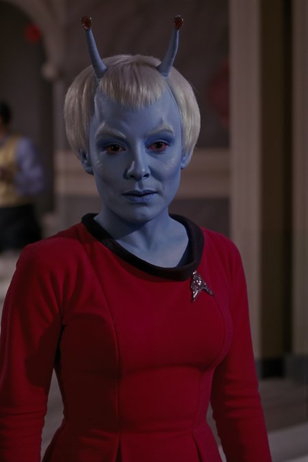 An andorian woman with blue skin and antennae and with short hair stands in the ancient temple wearing red TOS uniform dress with black collar (photography, high-resolution, dynamic, energetic,hyper-realistic, dramatic lighting, shallow depth of field.), <lora:aidmaMJ6.1-FLUX-V0.1:0.6><lora:Movie_Portrait><lora:Flux DetailerV2><lora:andorian_FLUX><lora:TOS_FLUXV1:1.1>