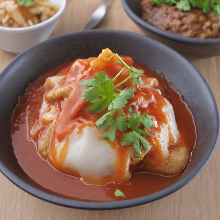 A high-resolution, hyper-realistic image of a bowl of bahuana with sauce, a popular dessert in many cuisines. The bahuana is perfectly made, with a smooth, round shape and a sweet, chewy texture. It's placed in a rustic ceramic bowl, with a generous drizzle of sauce on top. The scene is set in a homey kitchen environment, with all elements in sharp focus, creating a clear and detailed image. The lighting should be natural and soft, highlighting the appetizing qualities of the bahuana and the cozy atmosphere of the setting,<lora:bahuana2:0.85>