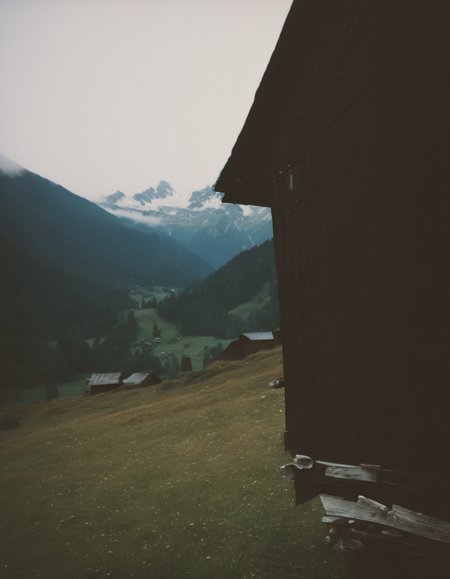 polaroid film photography, faded film, soft focus, film grain, an old barn in the austrian alps, 4k, uhd, masterpiece
