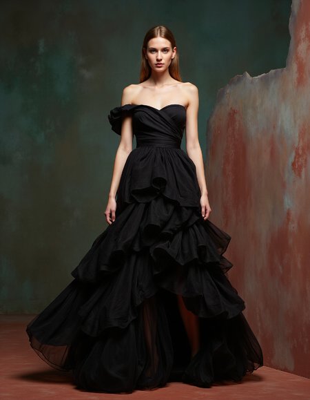 Fashion editorial photograph, a woman in a voluminous haute couture gown, dramatic lighting, studio shot, full-length, flowing fabric, soft focus background, Canon EOS 5D Mark IV, 85mm lens, f/2.8, ISO 200, 1/160 sec, shallow depth of field, focus on the model's face, elegant pose, neutral expression, high fashion styling, art direction, retouched, Vogue magazine style.
