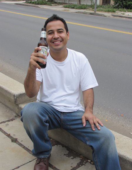 Hack Forums scrapped posted to WhatsApp r/me_irl r/pics Shot on iPhone Bad Quality Sharp photo of  Mexican worker wearing jeans and white tshirt , holding a bottle of bear, smiling, sitting on a curb by a road in Los angeles,  detailed skin, textured skin, hairy arms
 <lora:amateurphoto-6version:1>   <lora:Phlux:0.5>