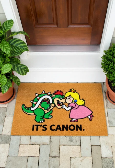 <lora:Welcome_Mat_Manufacturer_FLUX-000023:0.9>
The image is a photograph of a small outdoor entrance area, featuring a doormat with a humorous design. The doormat is rectangular and made of a textured, brown, coir material. It has a vibrant, whimsical design with the  text "It's Canon" and Bowser and Princess Peach kissing