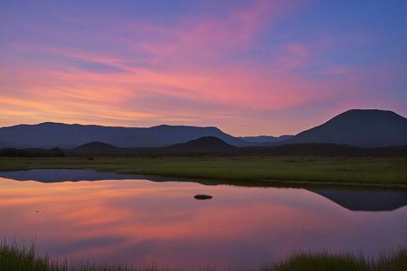 Stable_Yogis_PDXL_Positives,<lora:age_slider_v4:-2>,A breathtaking view of the Gran Sabana in Venezuela, with vast grasslands and unique rock formations, The scene is set during twilight, with the sky painted in deep blues and purples, The atmosphere is mystical and serene, inviting contemplation of the natural landscape,(A serene twilight by a still lake, where the sky reflects shades of pink and orange. The atmosphere is calm and reflective, evoking a sense of peace and solitude),âââ