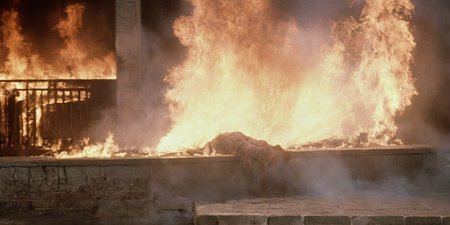 Horror-themed,  <lora:Fright Night 1985 Film Style:1>
Cinematic Medium Shot Film Footage captured by Panavision Cameras and Lenses a huge fireball is hitting a vampire creature person, laying on a wall with a huge fire spewing on, Fright Night 1985 Film Style, Eerie, unsettling, dark, spooky, suspenseful, grim, highly detailed
