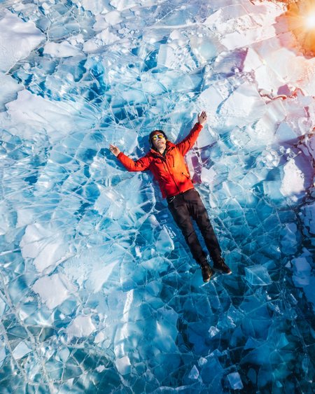 vertical perspective aerial photography, sunlight_shadow, blue ice, looking_up,  lying_down,  <lora:sky:0.8>