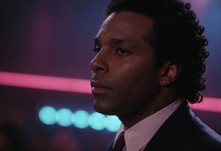 cinematic film still (Rico Tubbs), MiamiVice, indoors, club, neon lights, closeup . shallow depth of field, vignette, highly detailed, high budget, bokeh, cinemascope, moody, epic, gorgeous, film grain, grainy